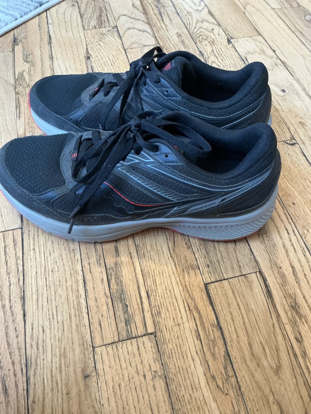 Saucony Men's Black Athletic Shoes with Gray Soles and Red Trim